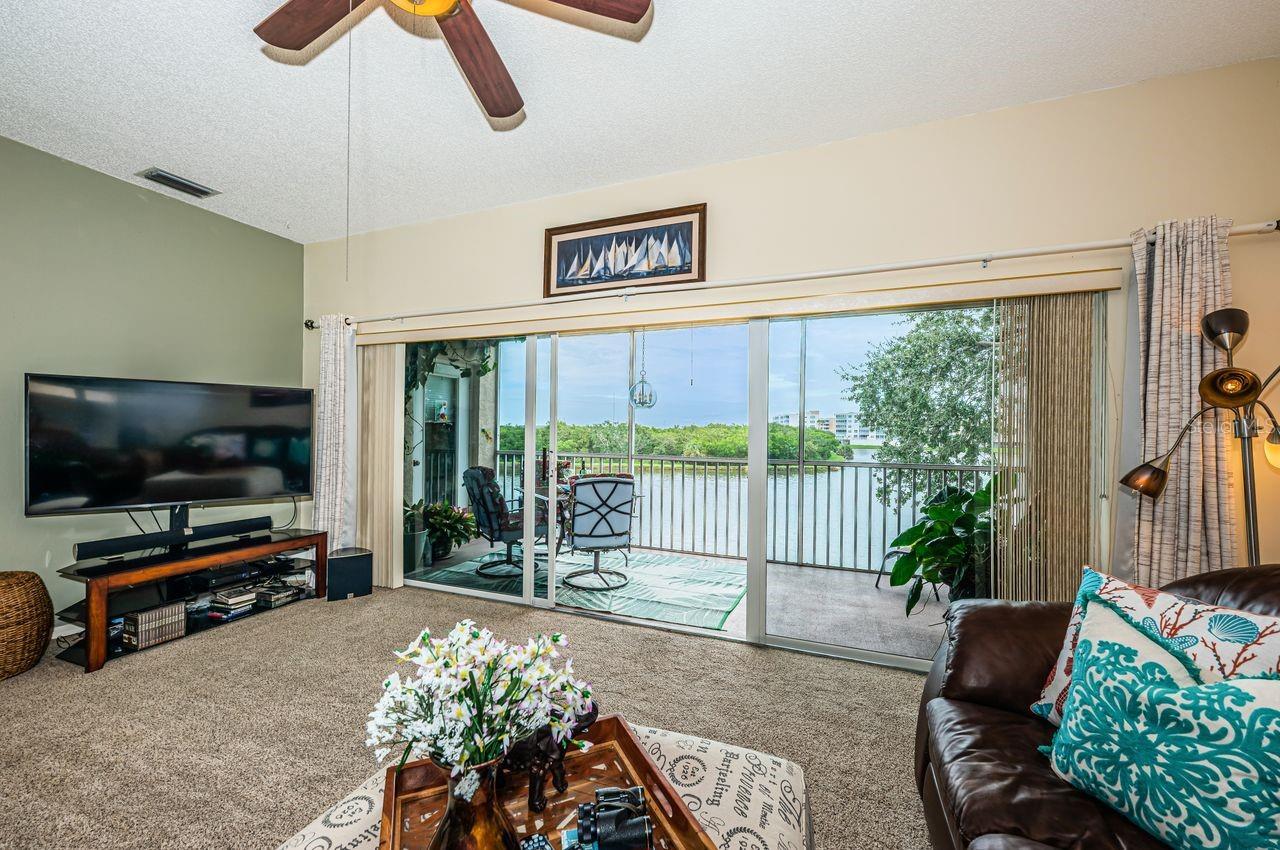 Open layout connects kitchen, dining, and living areas with water views from nearly every room.