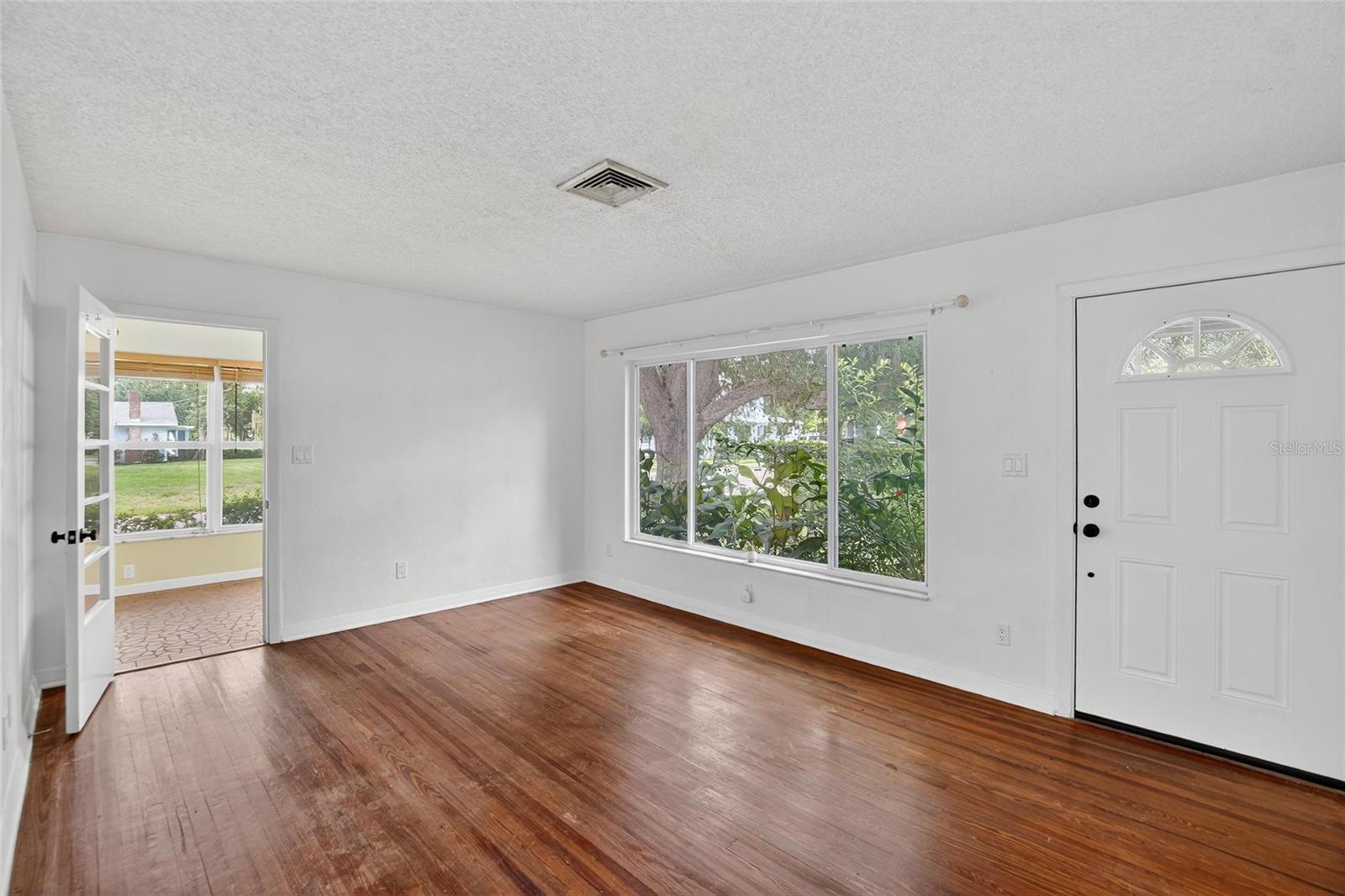 LIVING ROOM WITH SUNROOM (OFFICE) AND SECONDARY ENTRY