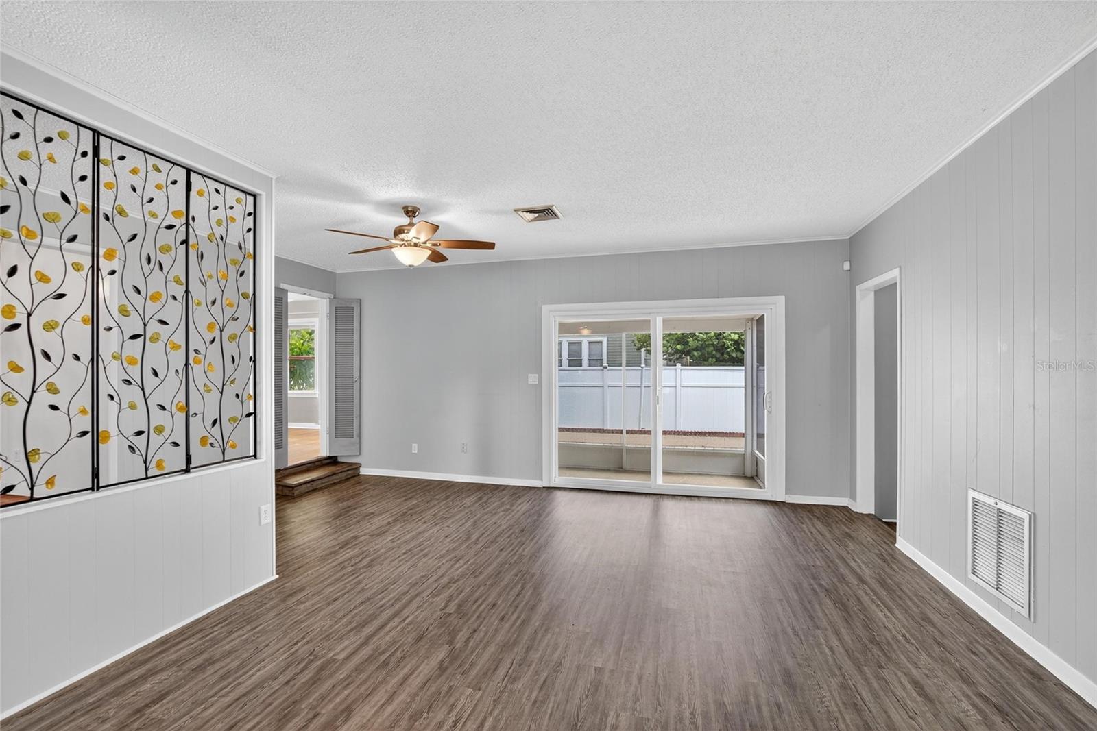 FAMILY ROOM TO SCREENED LANAI WITH ADDITIONAL BEDROOM 2 ENTRY ON LEFT