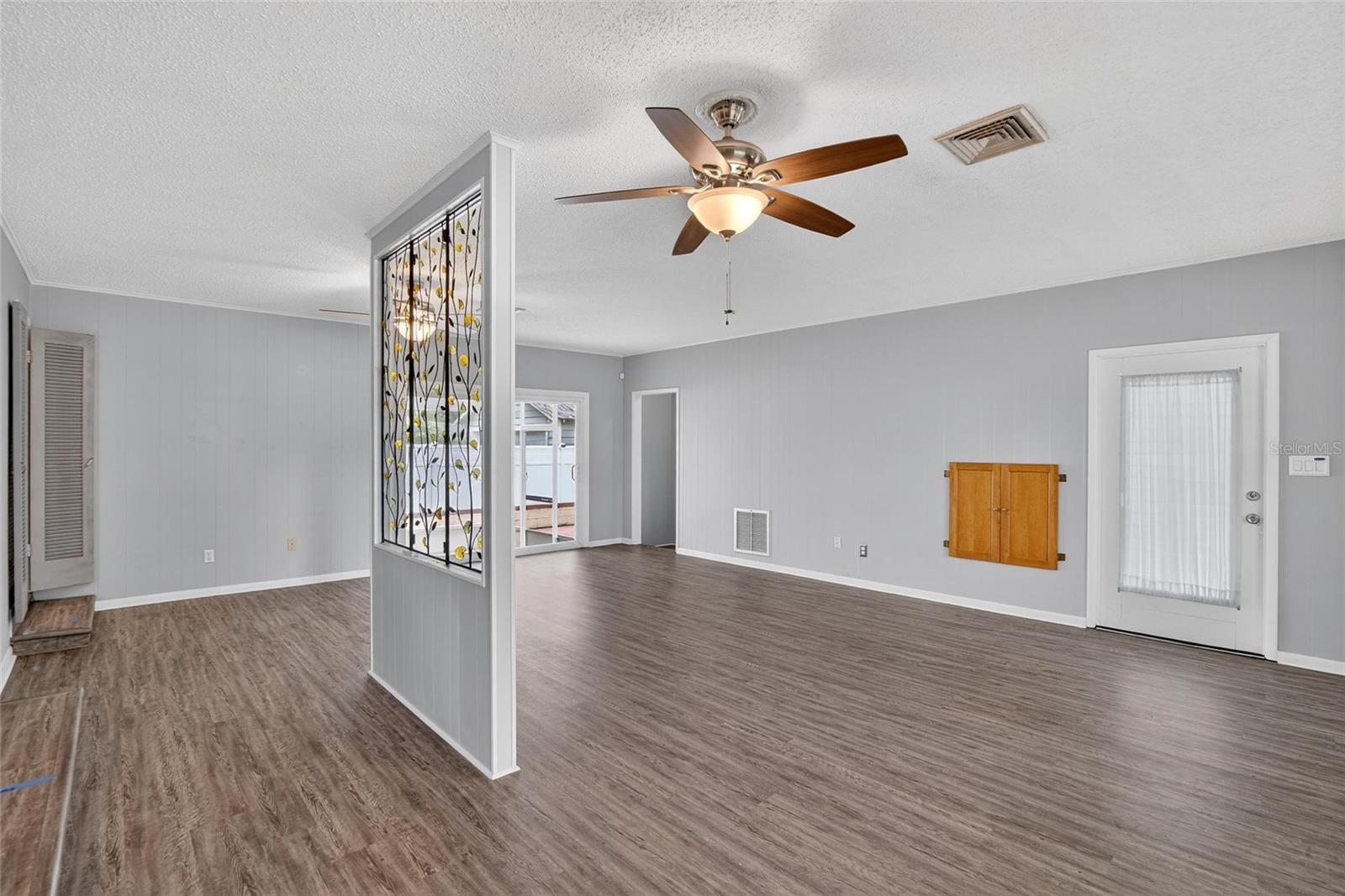 FAMILY ROOM TO LAUNDRY ROOM AND CARPORT ENTRY ON THE RIGHT