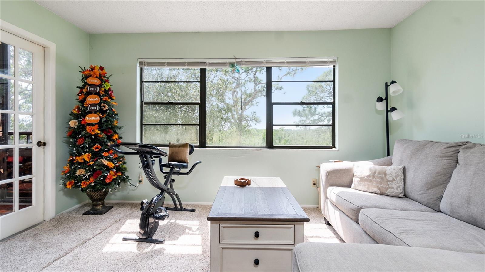The Sunroom, just off the kitchen, doubles as a separate family room, and offers access to the screened-in lanai!