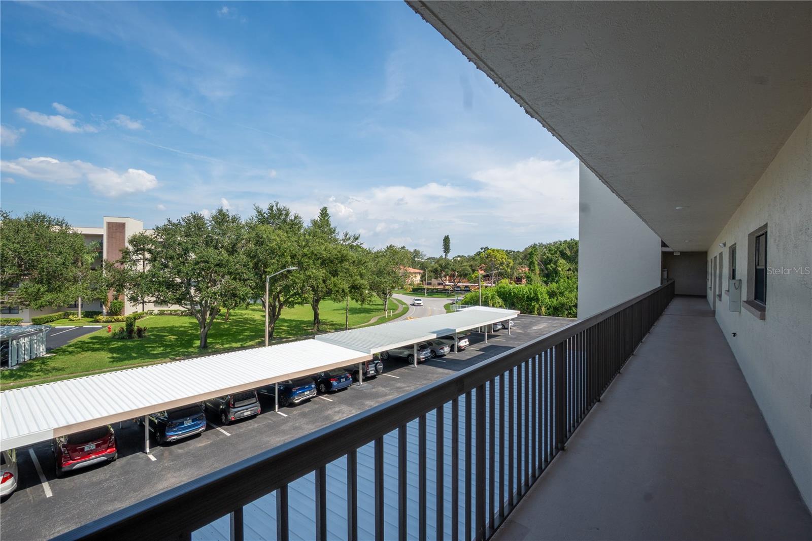 The beautiful covered breezeway offers a view along the quick walk from the elevator to your unit.