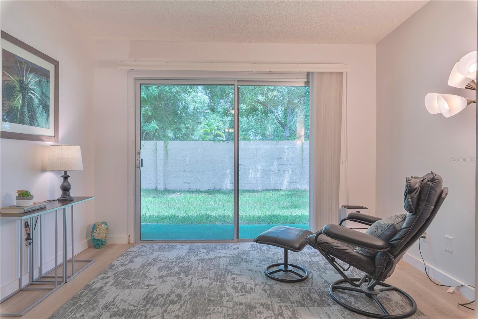 Furnished bonus room with sliders leading to patio.