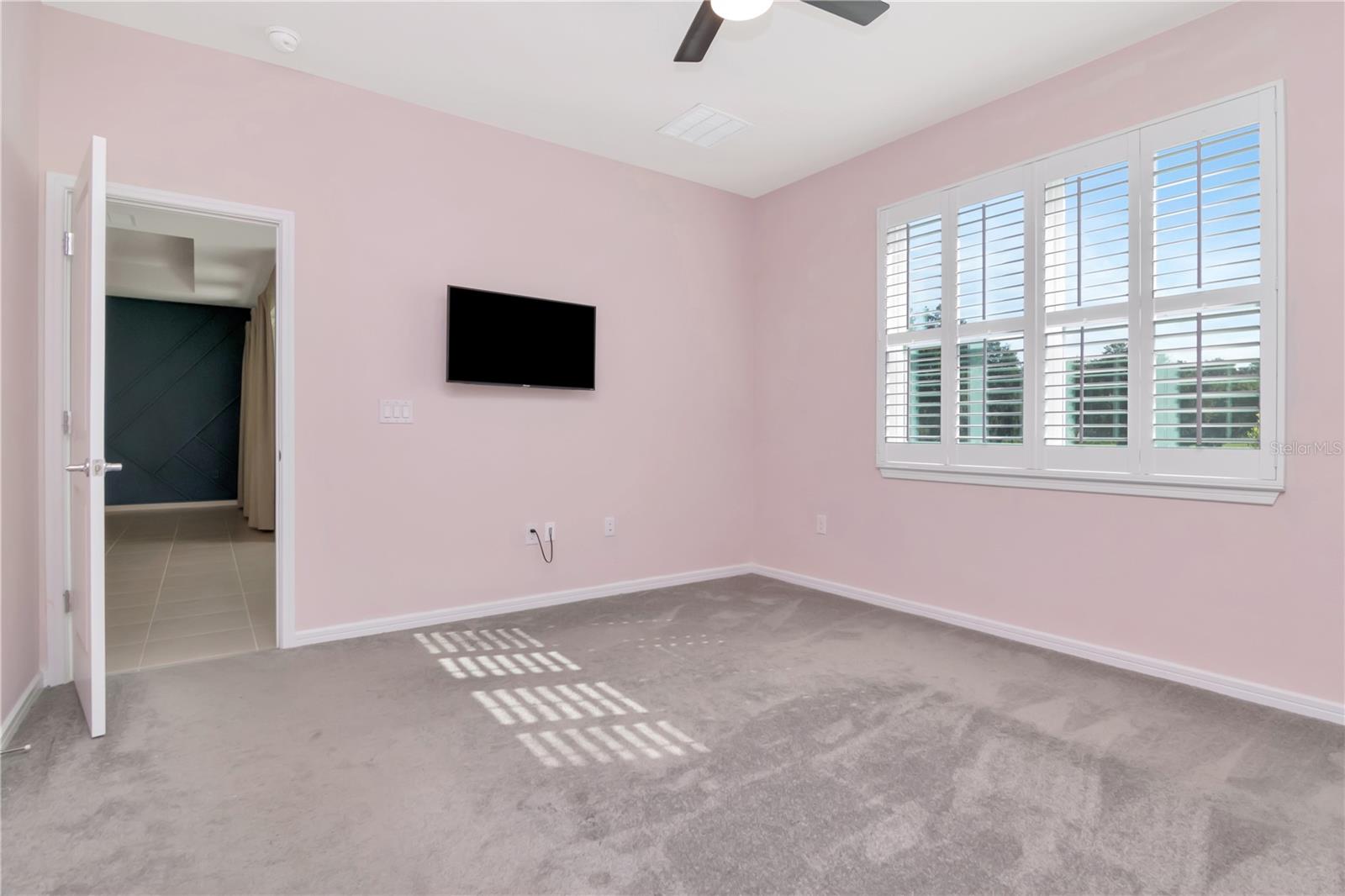 Primary Bedroom with Plantation Shutters and Ceiling Fan