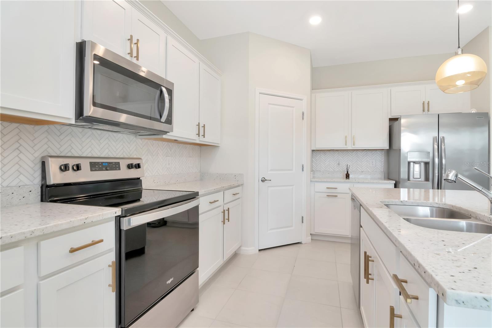 Kitchen with White Cabinets and Quartz Countertops