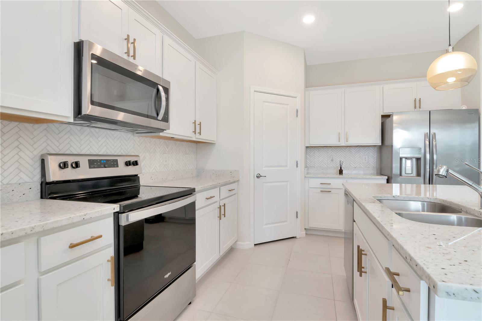 Kitchen with White Cabinets and Quartz Countertops