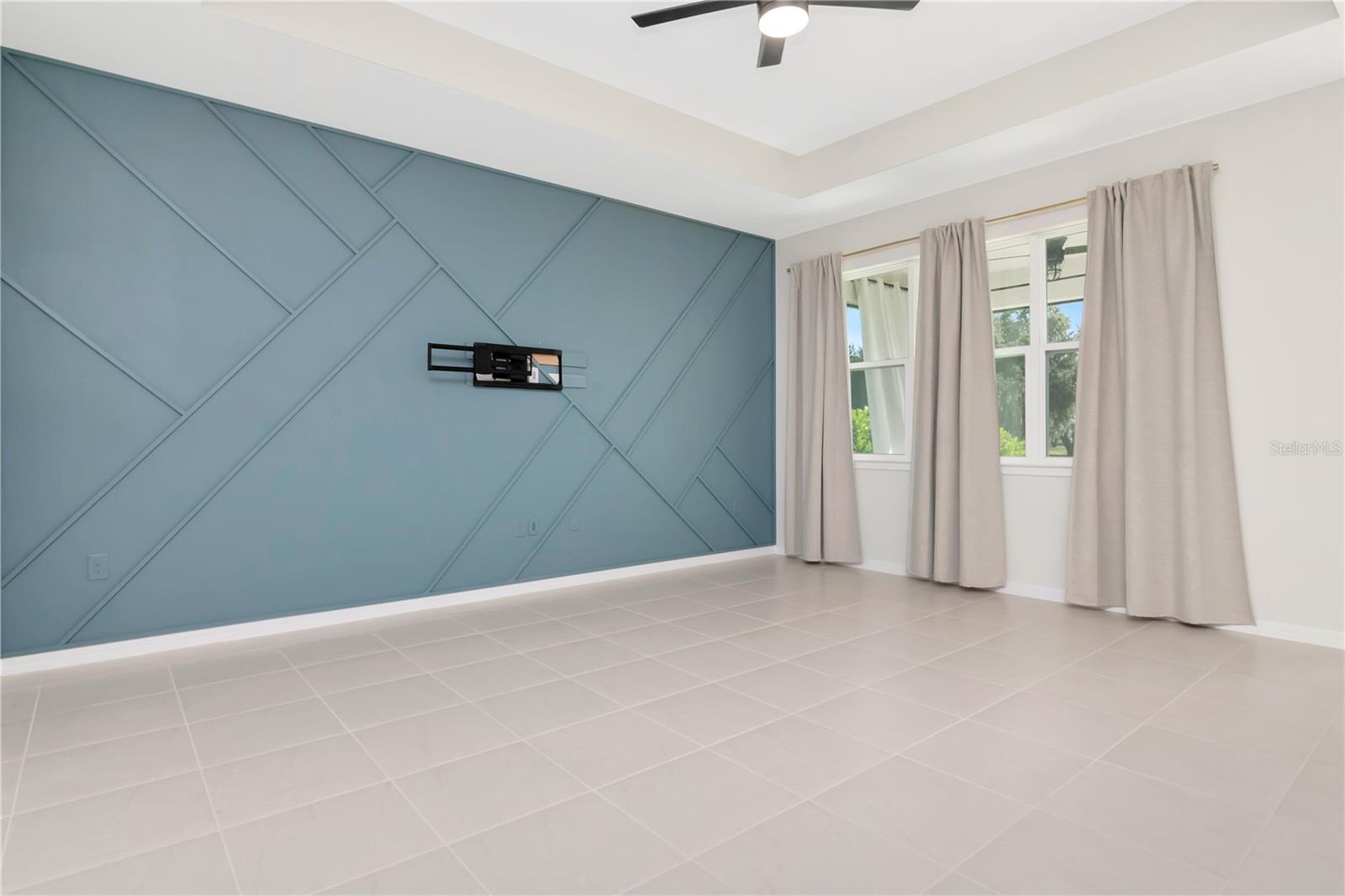 Living Room with Tray Ceiling, Decoartive Accent Wall and Ceiling Fan