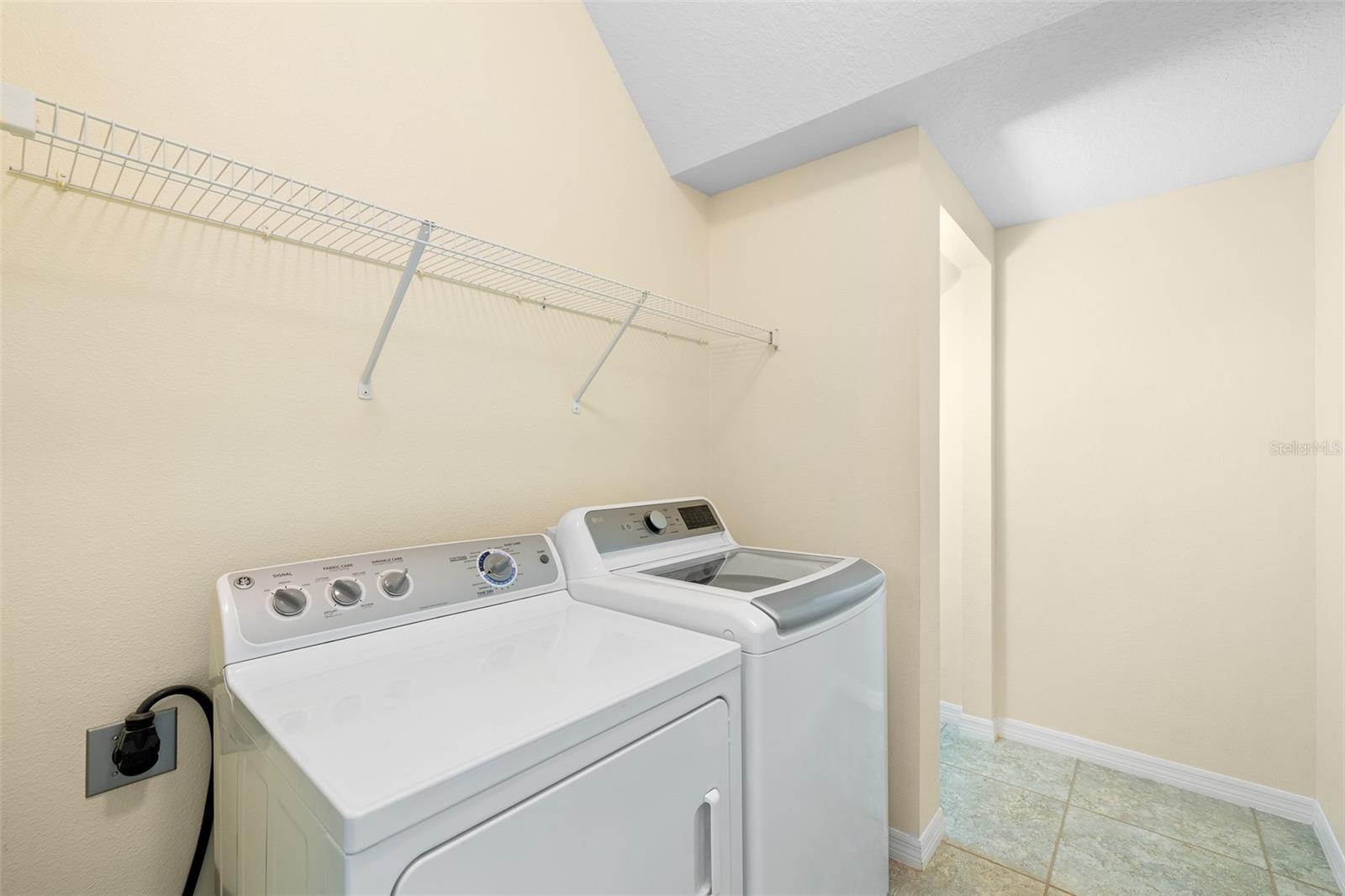 Laundry room on the first floor with additional storage.
