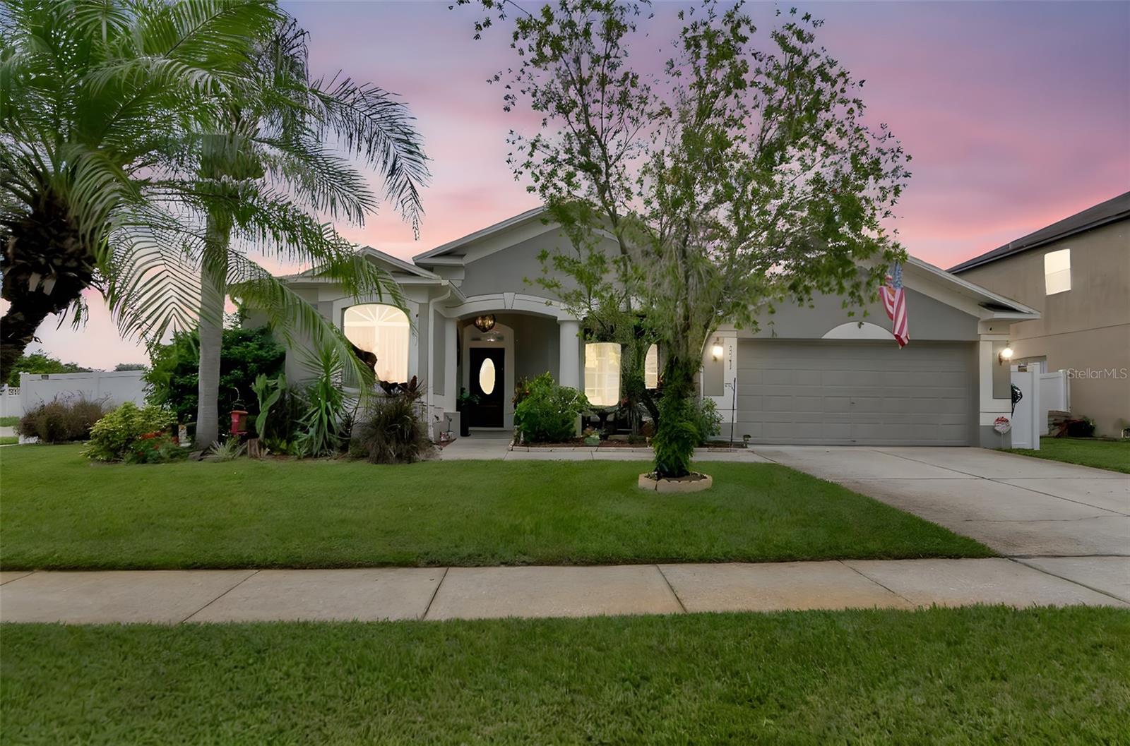 Twilight View of Front of Home with Manicured Landscaping