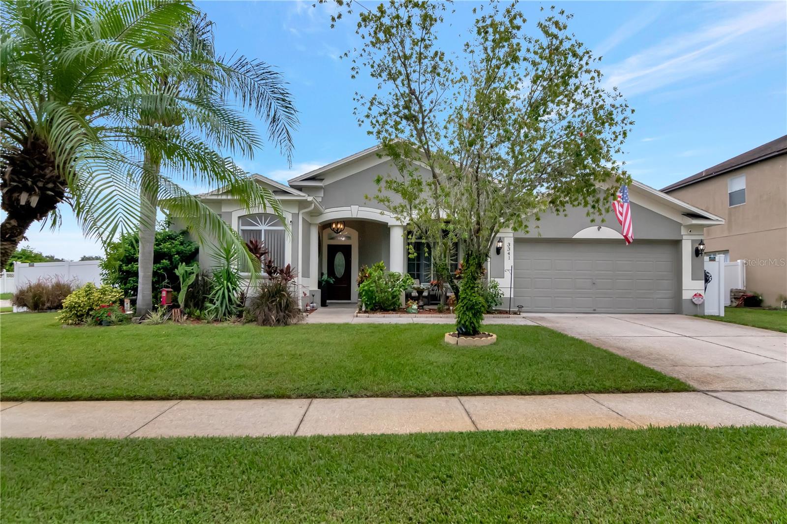 Front of Home with Covered Front Porch and Manicured Landscaping