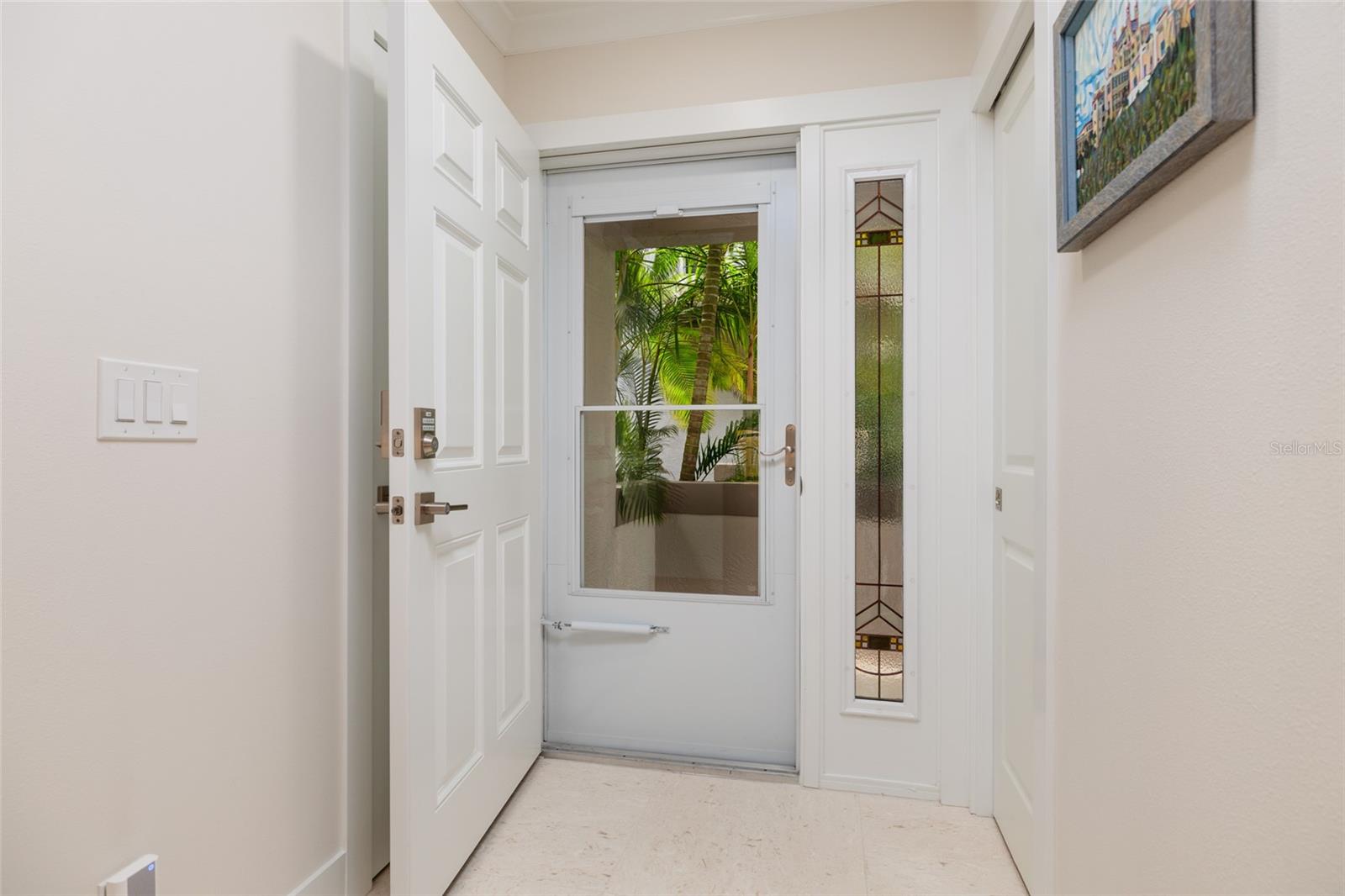 Welcoming entryway with stylish door with modern hardware & keyless entry