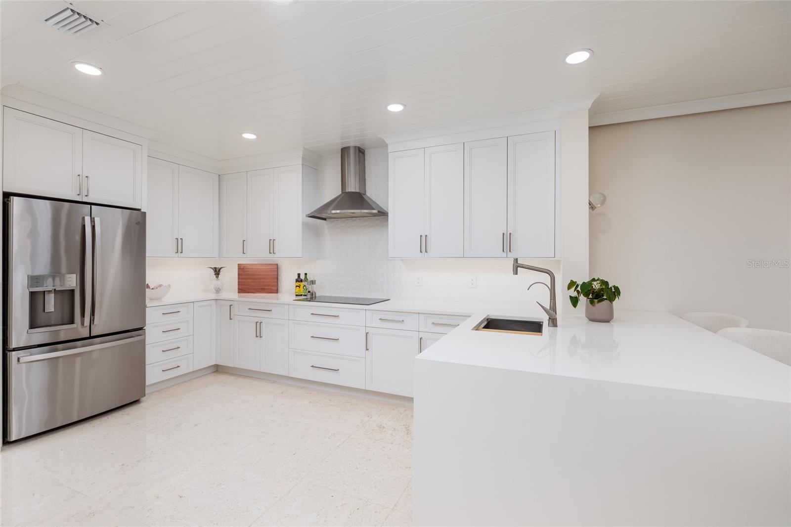 Waterfall-edge peninsula and premium appliances