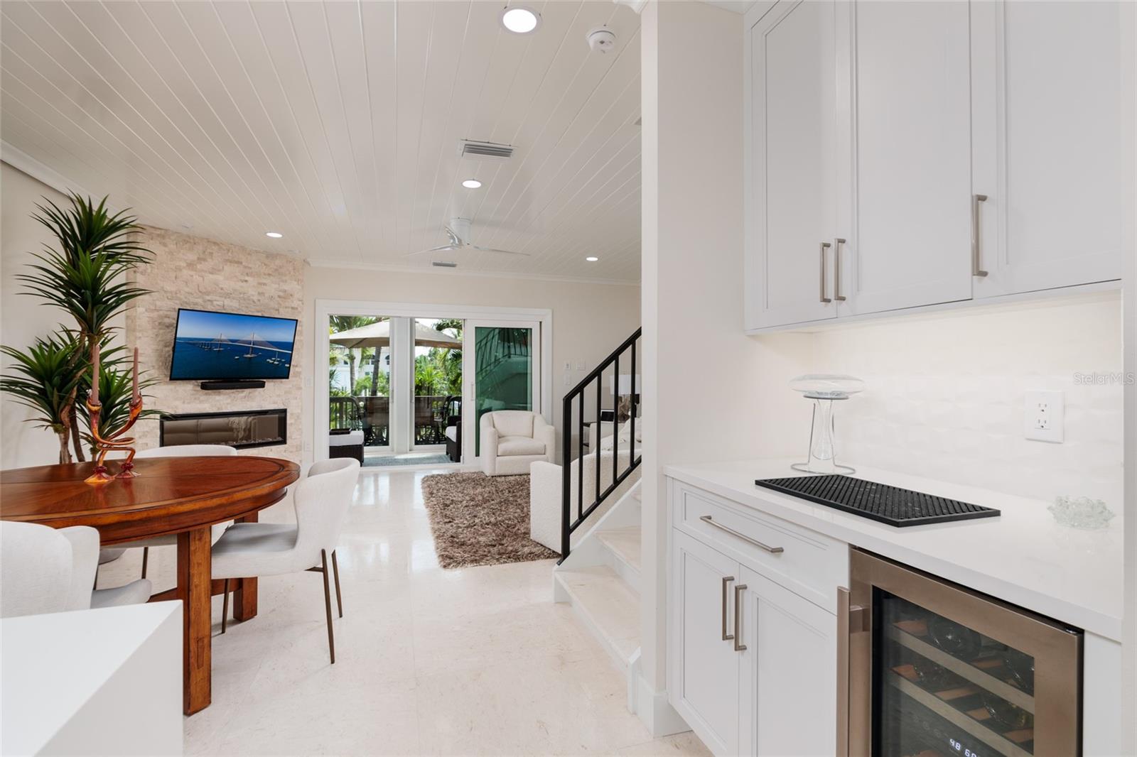 Built-in wine cooler and glassware storage for entertaining-note electric fireplace under the TV