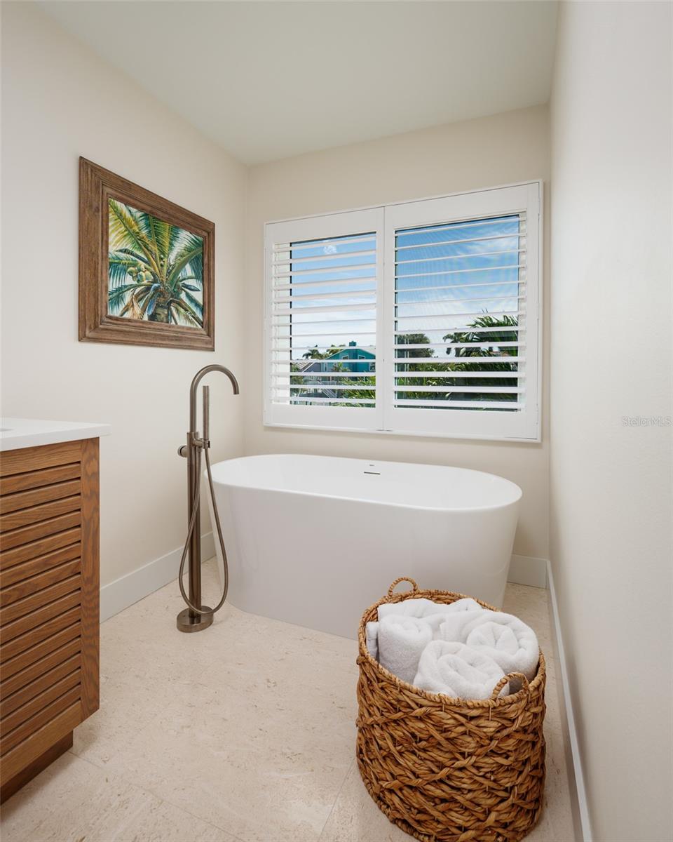 Free-standing soaking tub with water view