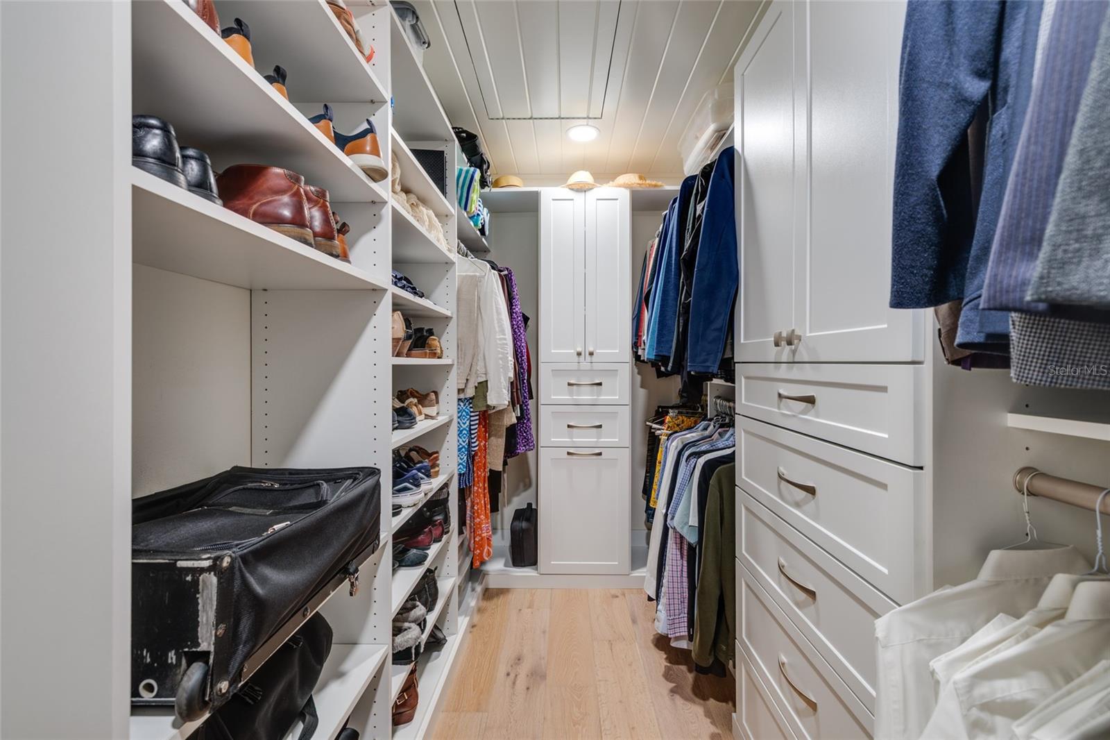 Custom closet with abundant adjustable  built-ins.