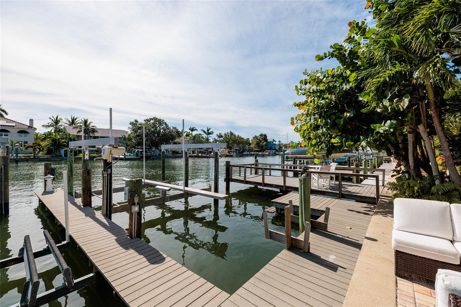 Deeded 24-ft wide slip with 20,000-lb lift, steps from your back door with no fixed bridges.