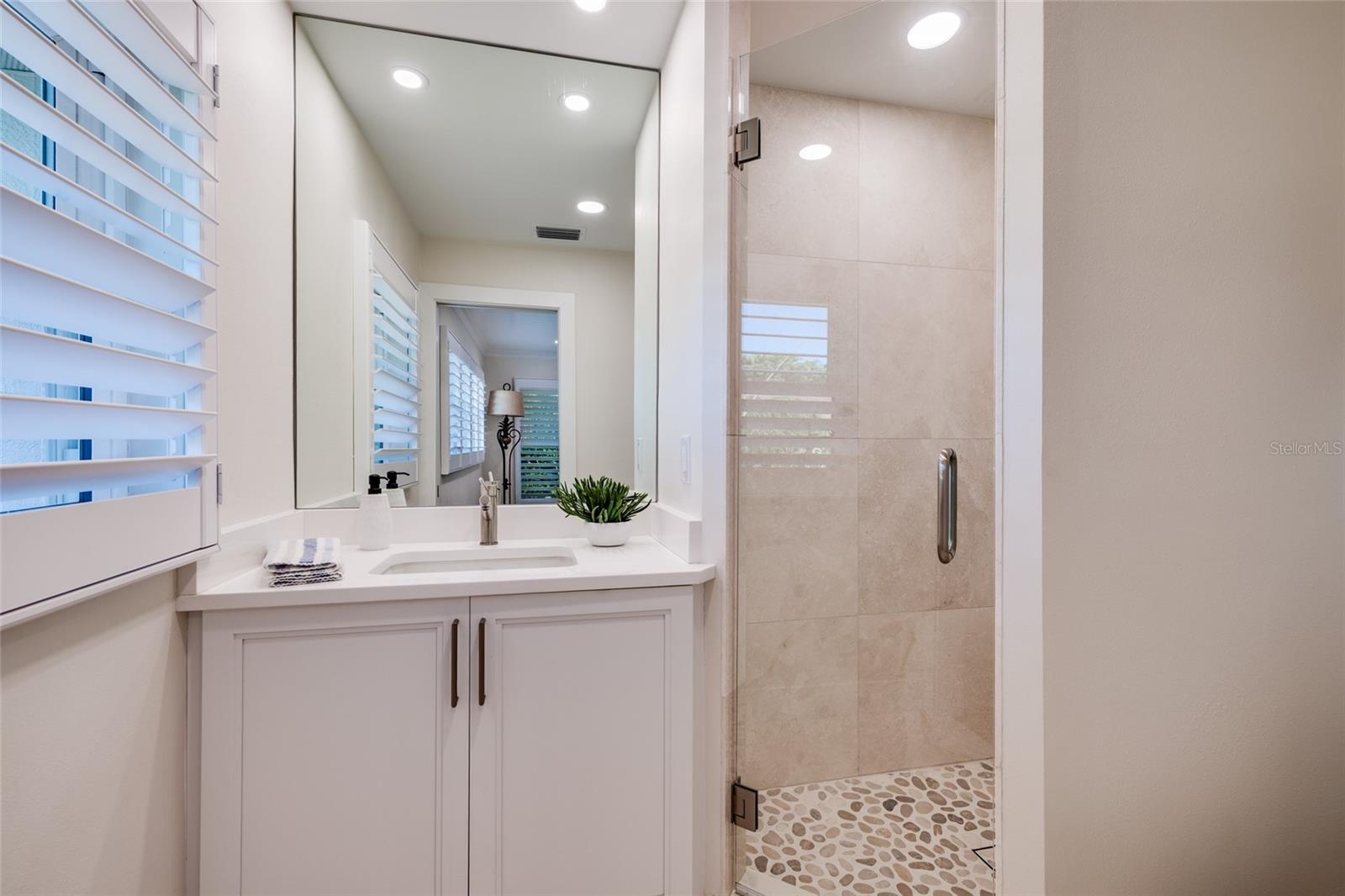 Ensuite bath with quartz vanity and rainhead shower