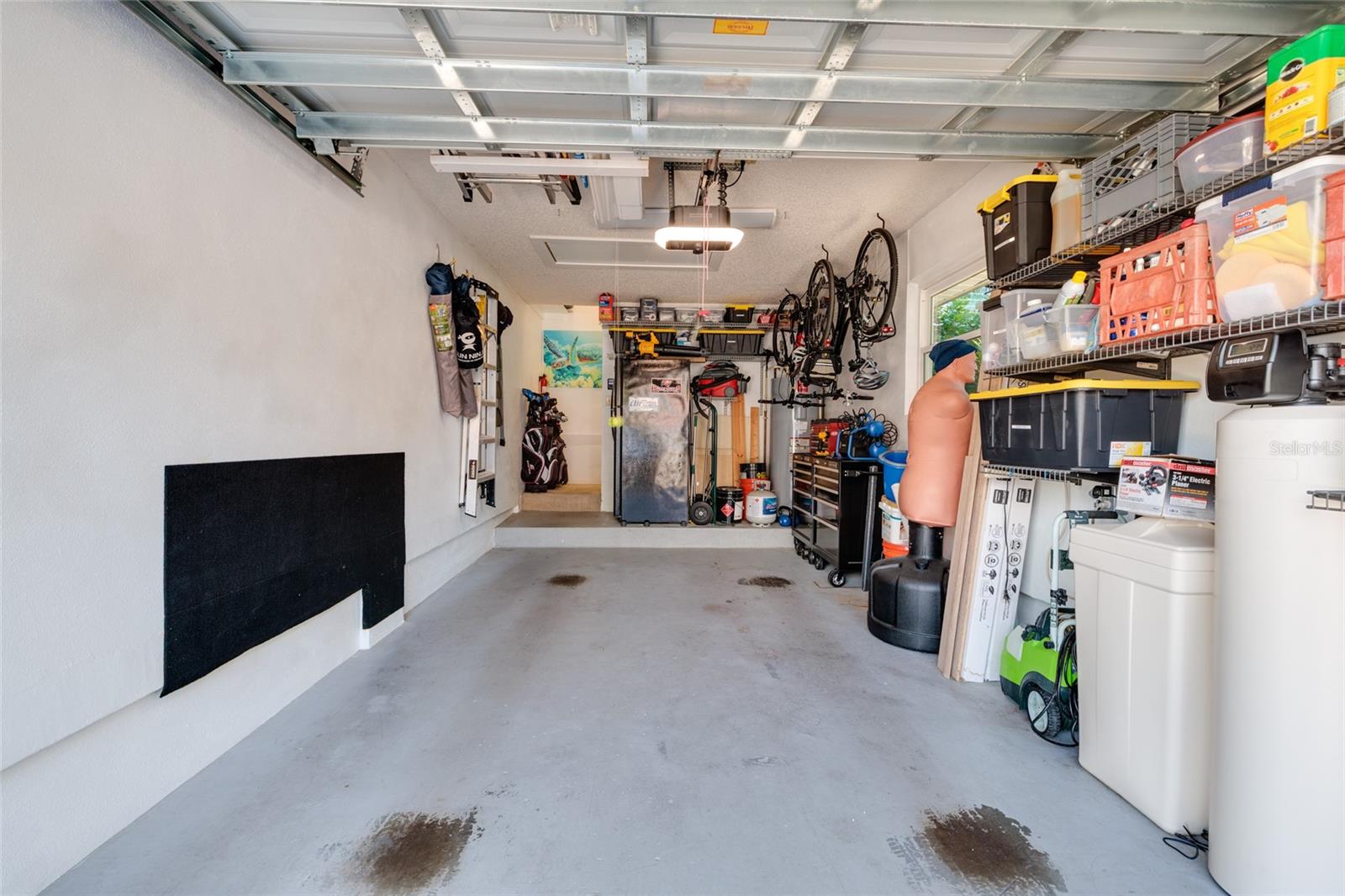 Oversized one-car garage with wind-rated door and storage
