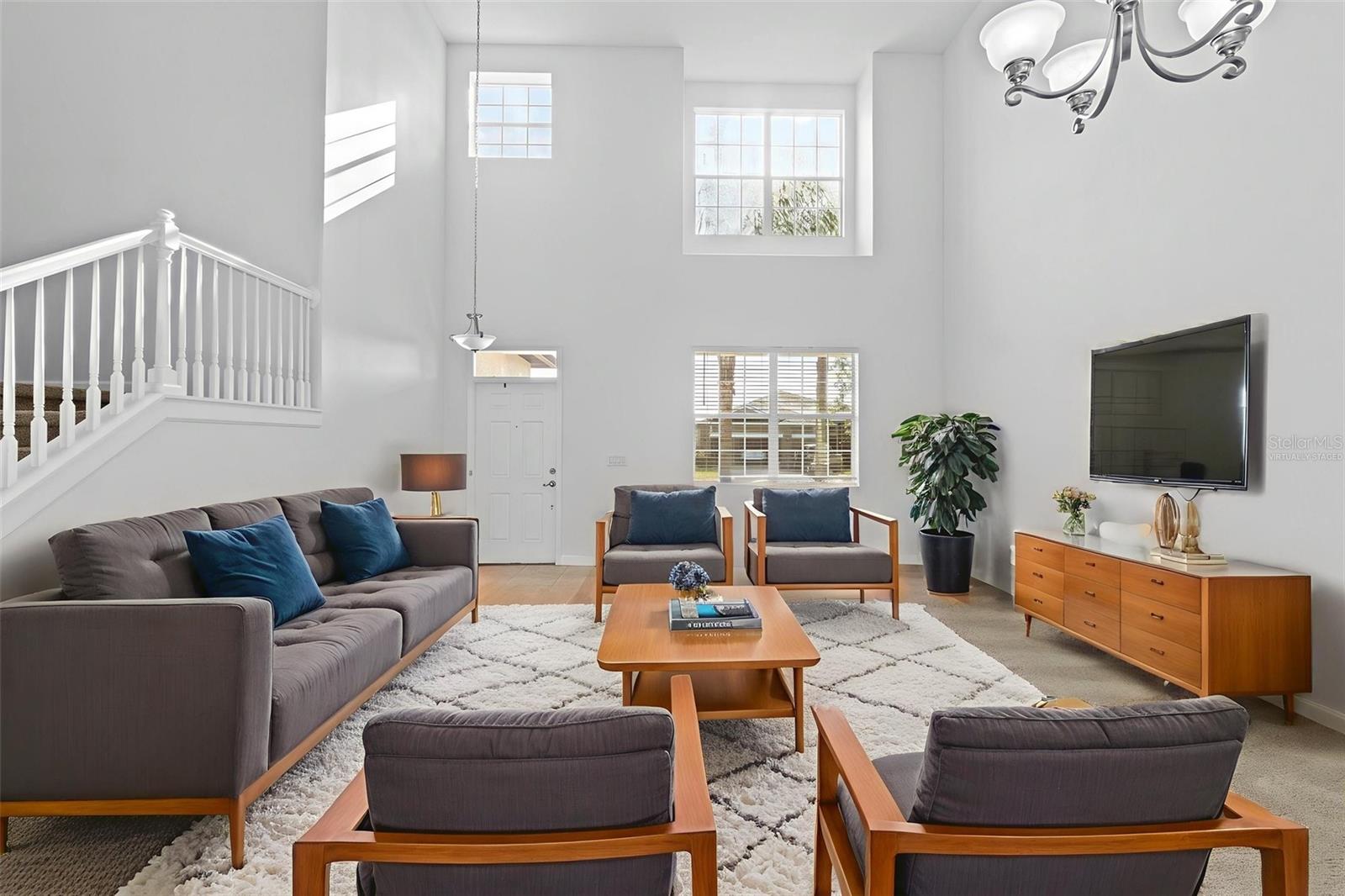 Virtually Staged Entryway Living Room and Dining Area with High Ceiling