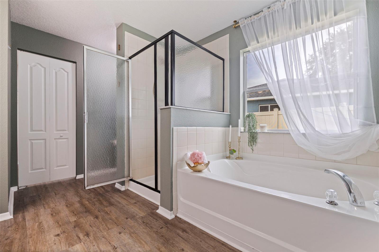 Primary bath with standalone shower and soaking tub.