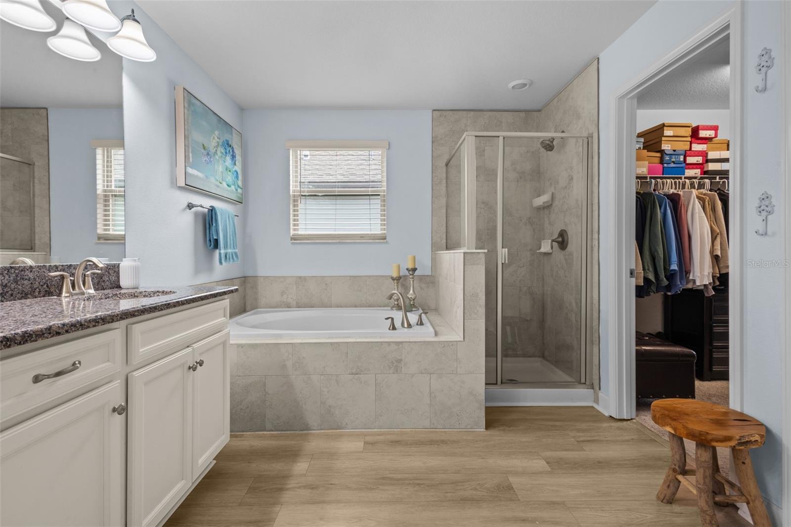 Luxury en suite with double sinks, garden tub, and walk-in shower.