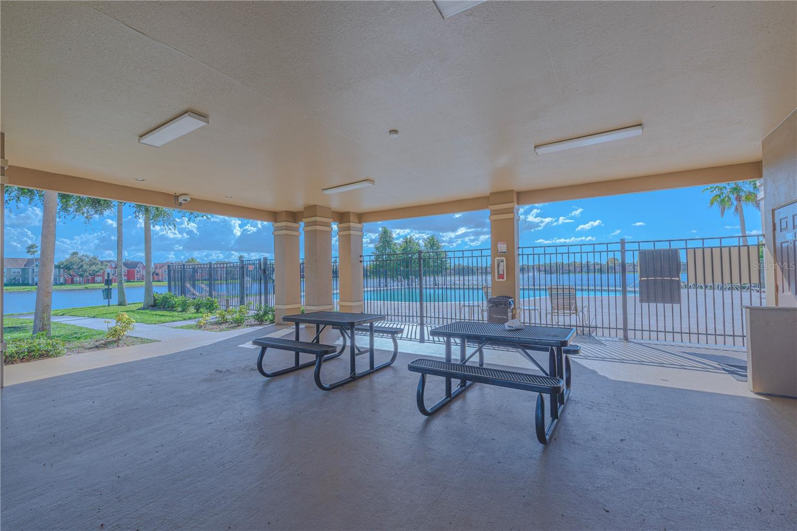 Pool lanai with picnic tables.