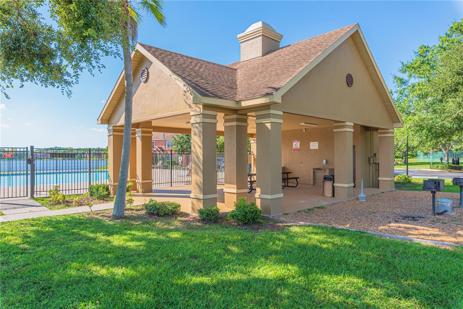 Covered pool lanai with lake view.