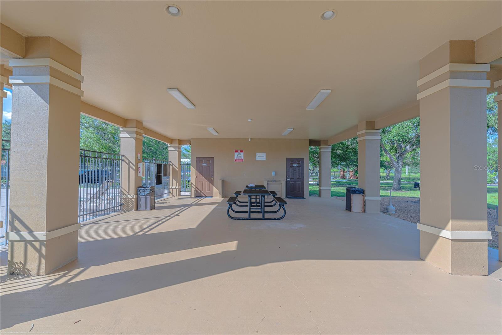 Picnic tables and BBQ station by the pool.