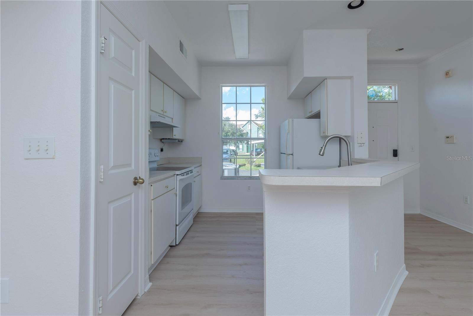 Kitchen with closet pantry.