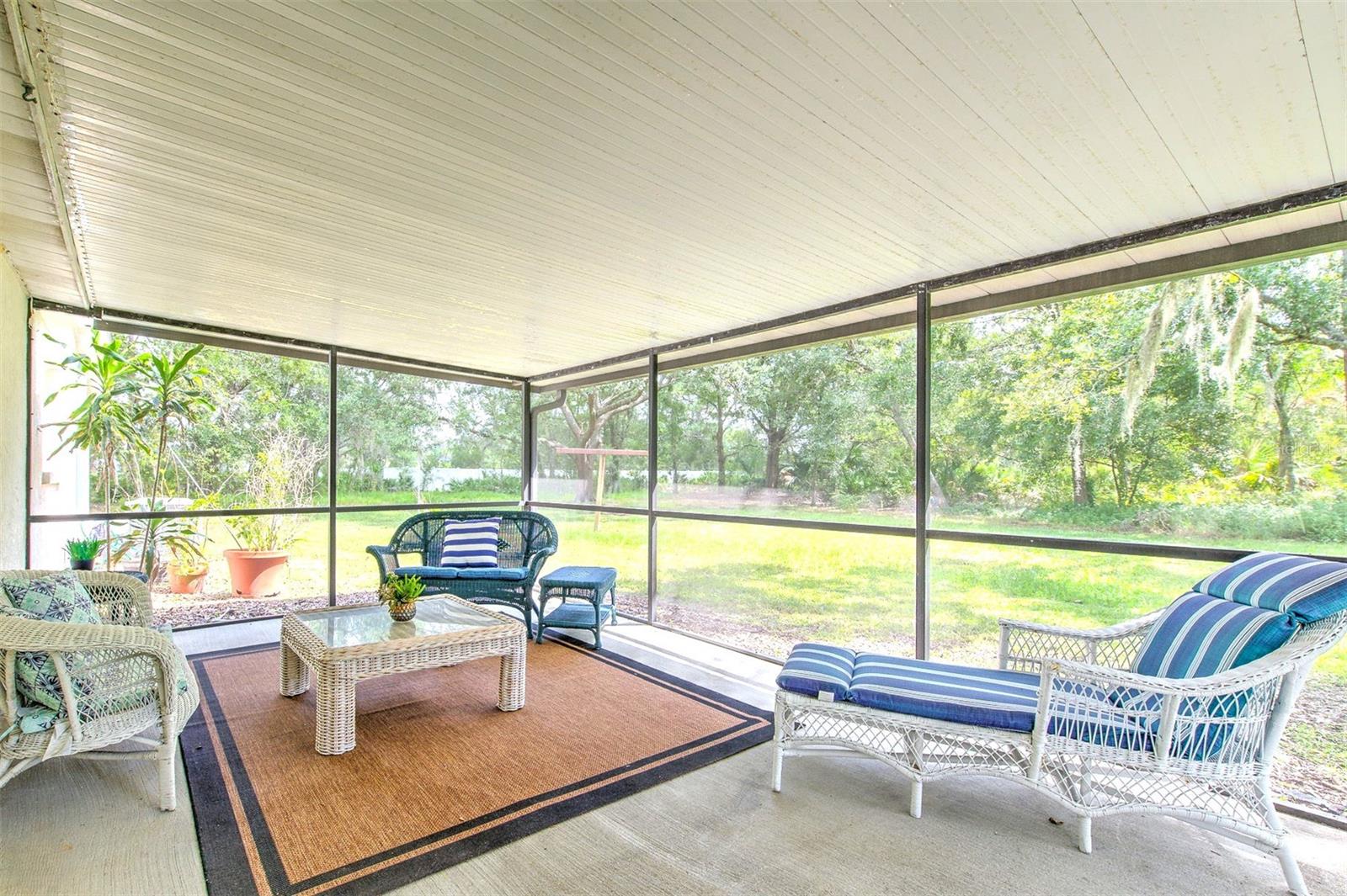 HUGE Covered & screened-in back patio with peaceful view of the backyad.