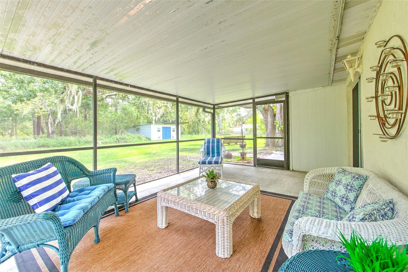 HUGE Covered & screened-in back patio with peaceful view of the backyad.