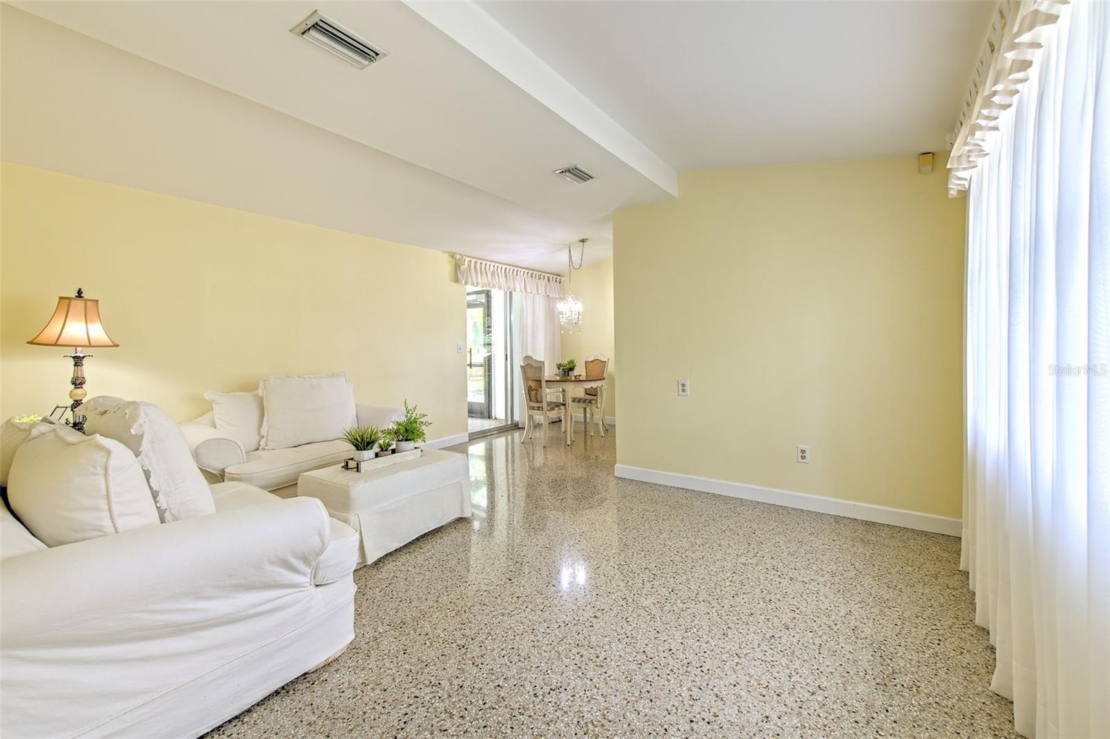 View of open living room & dining area from the front entrance