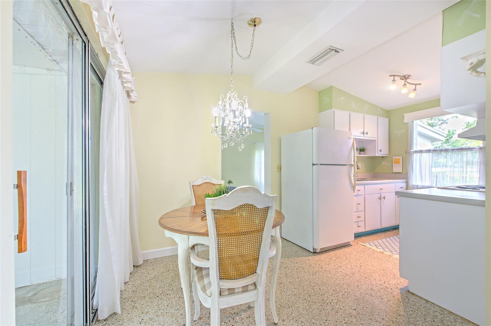 Dining Area next to kitchen with sliding door to covered & screen-in patio