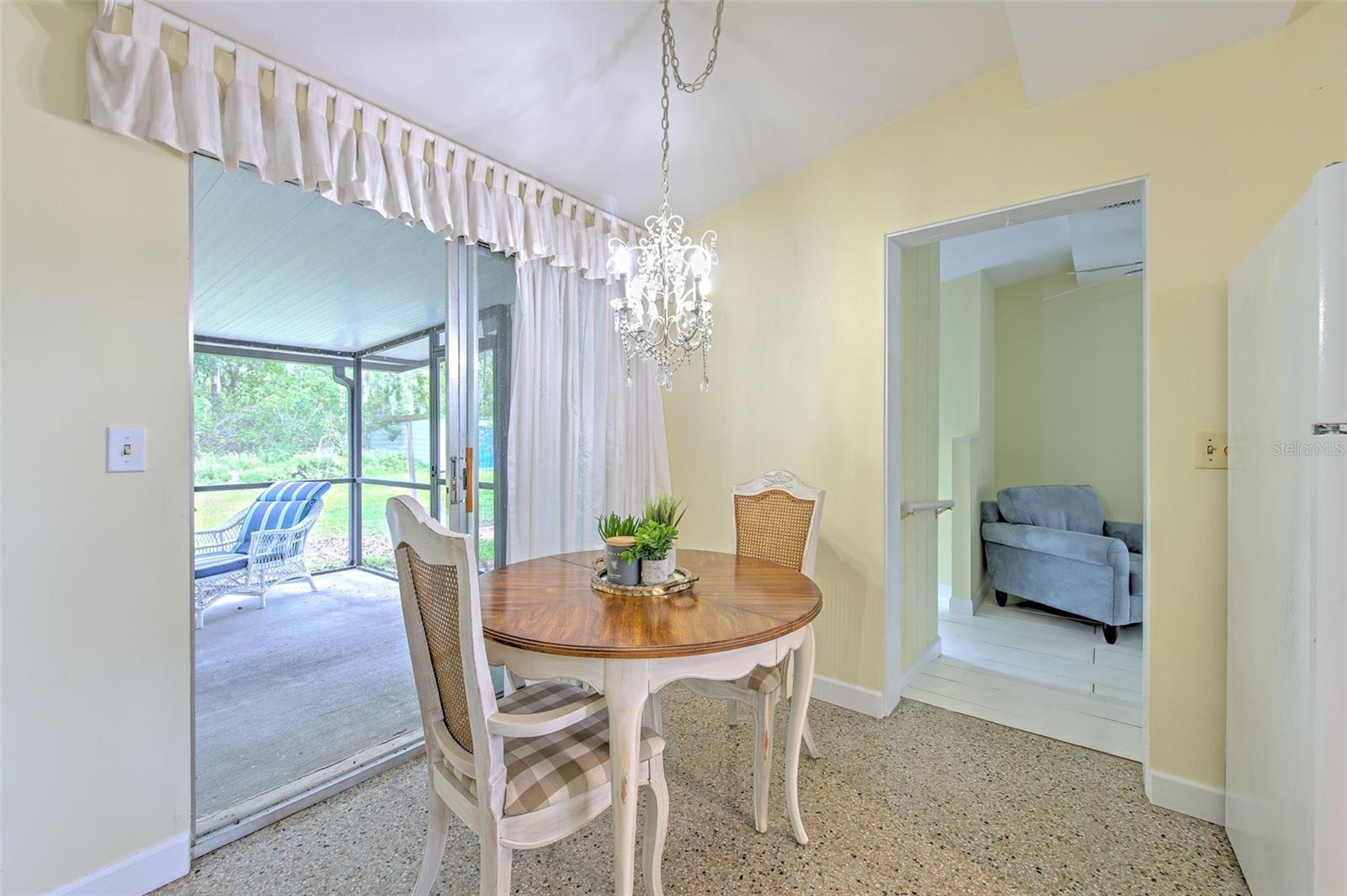 Dining Area next to kitchen with sliding door to covered & screen-in patio