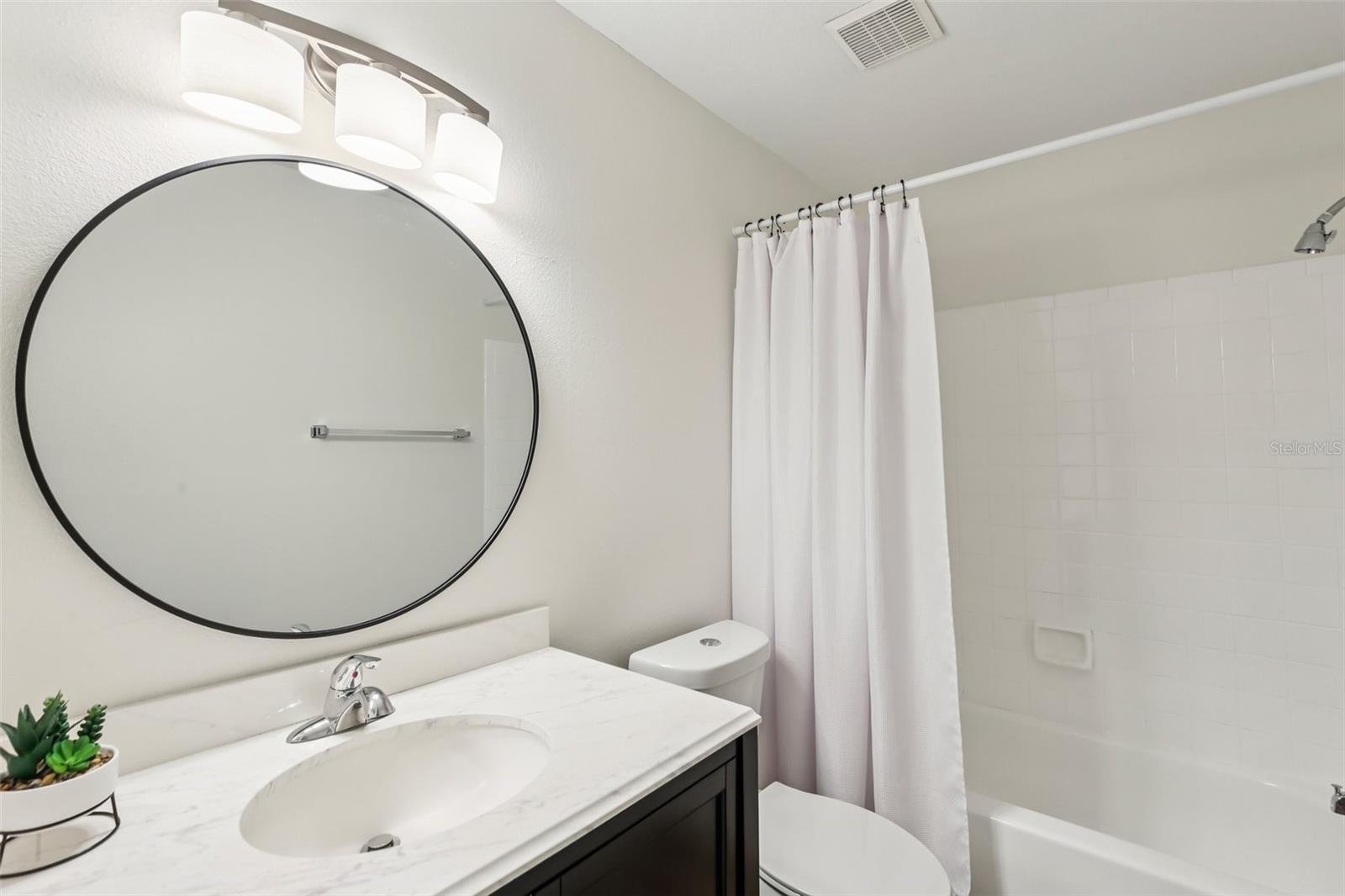 Second bathroom with tub and shower.