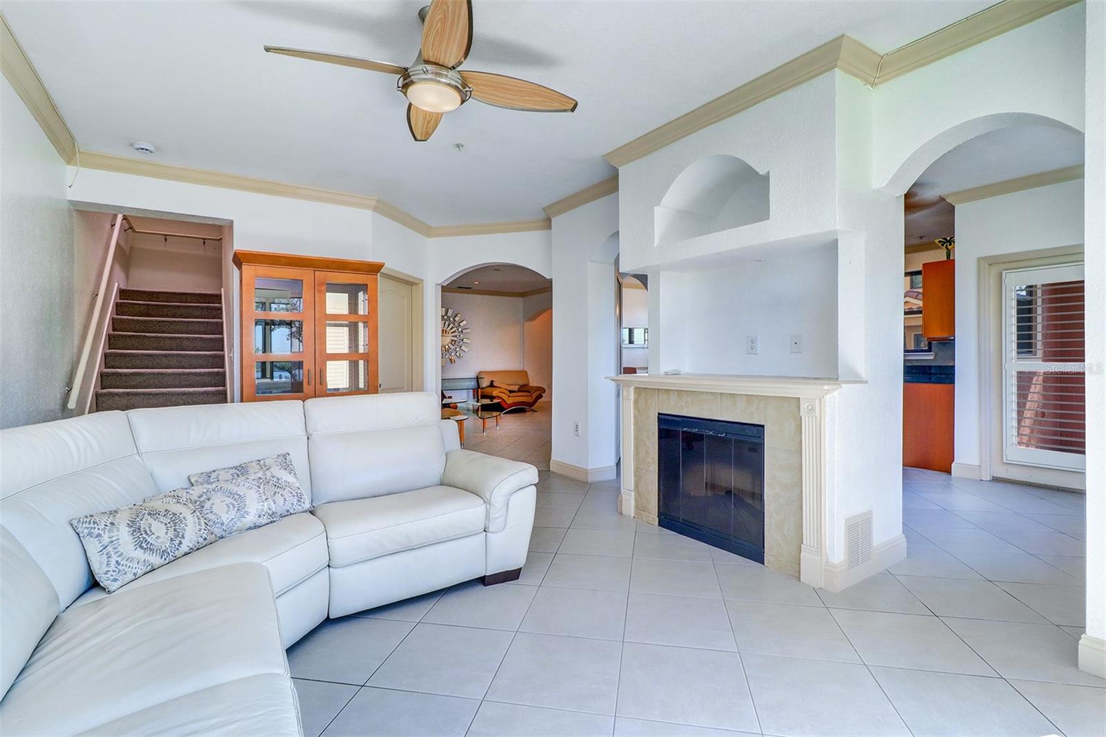 Family room with gas fireplace with the kitchen entry to the right and living area straight ahead