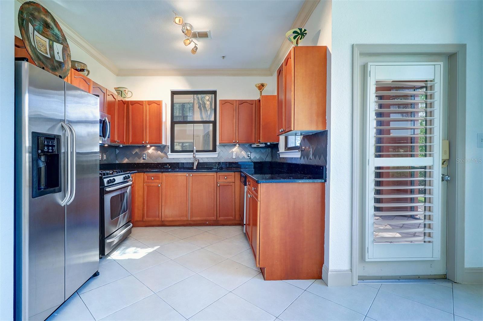 View of the kitchen from the breakfast nook/door to the right goes out to the screened lanai/porch