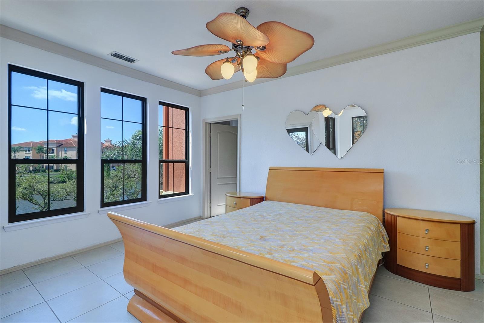 A wall of windows in the primary bedroom with gorgeous view