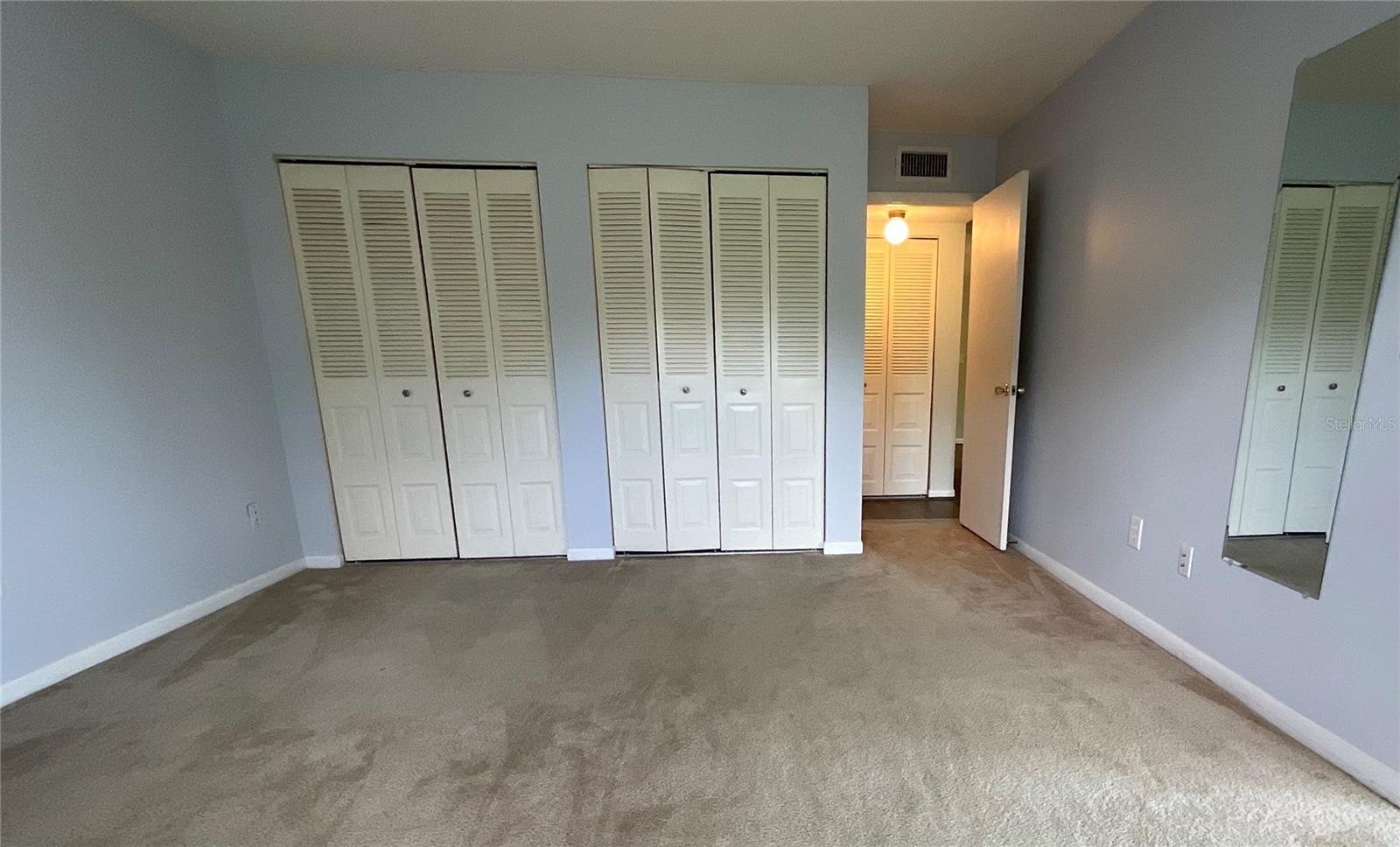 27-Bedroom two large closets and door to hallway