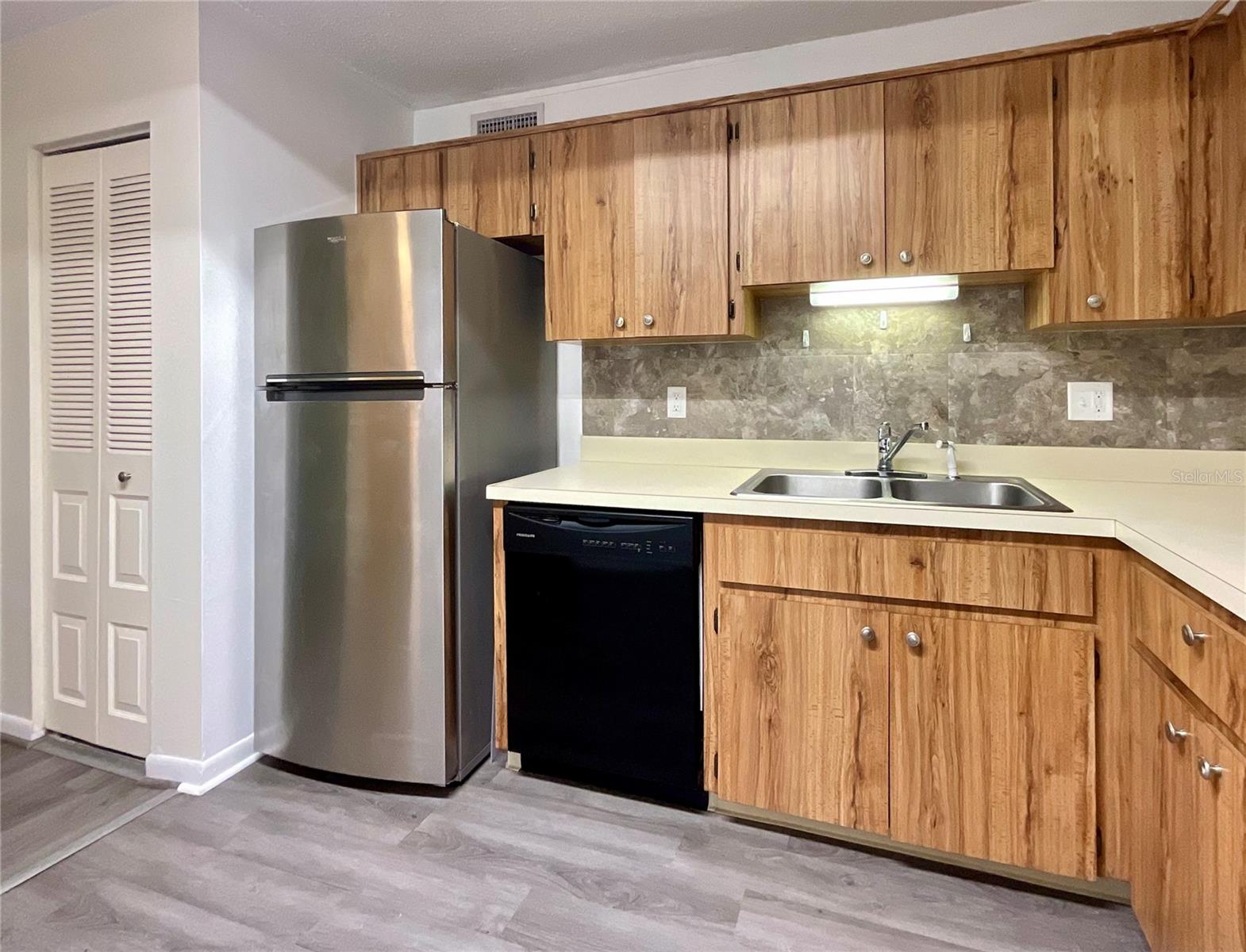 6-Kitchen Refrigerator and dishwasher area. Closet with w/h and a/c