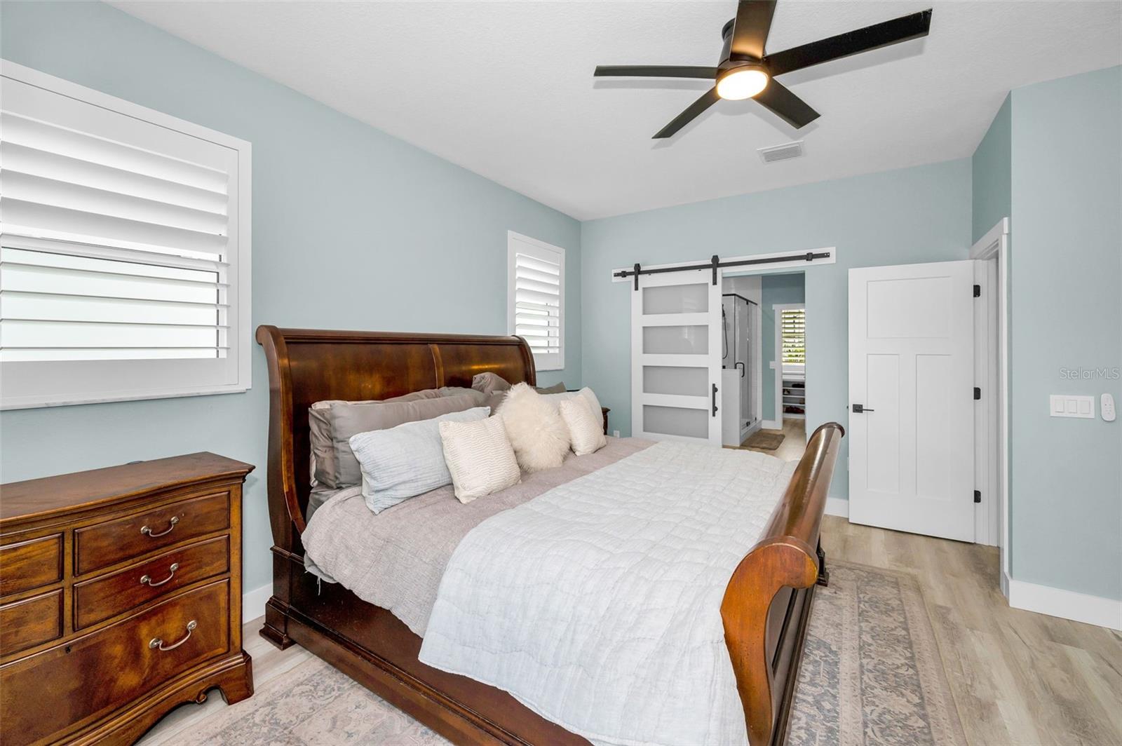 Primary Bedroom with custom barn door to bath