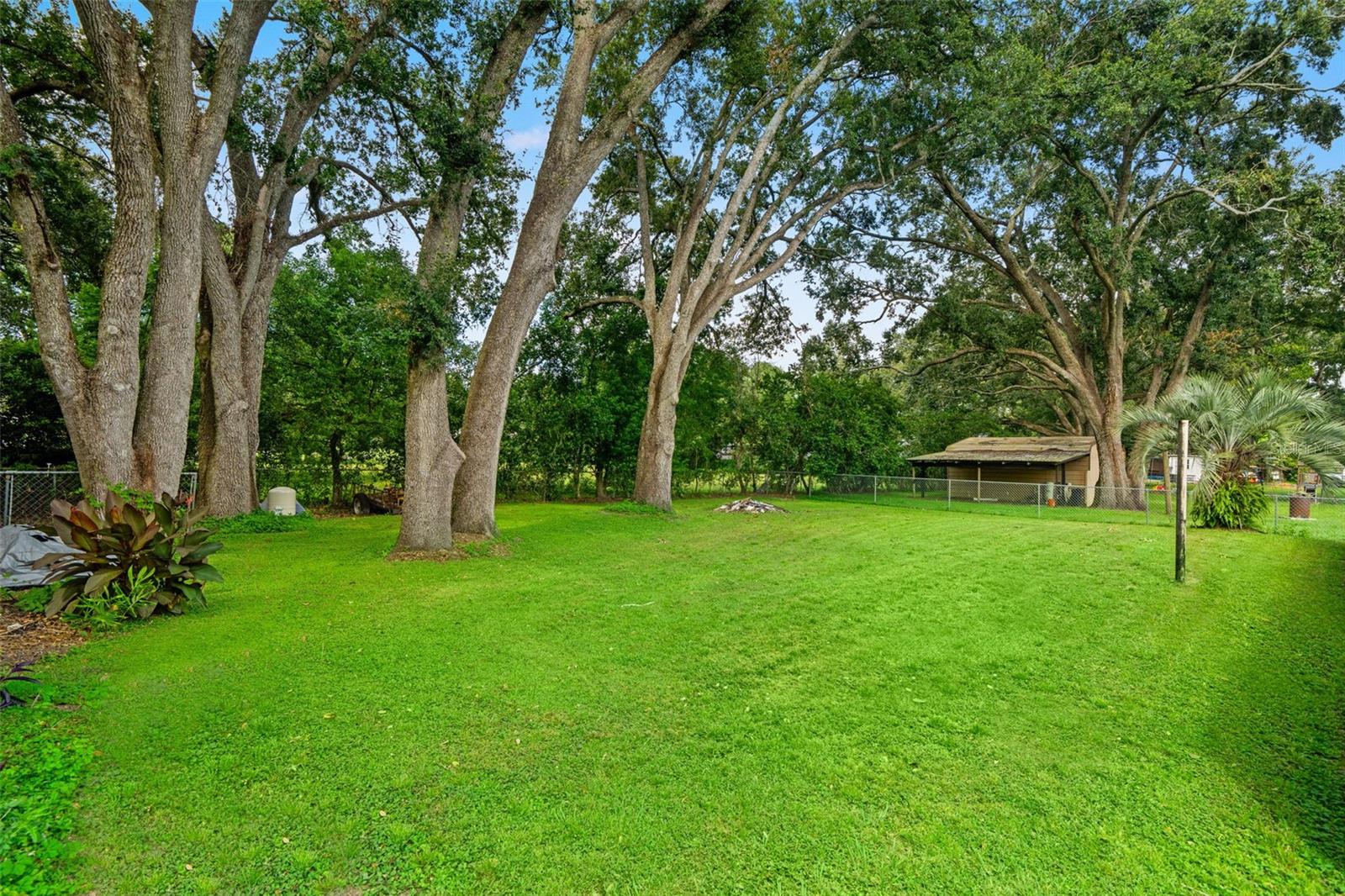 Backyard is fenced on three sides.