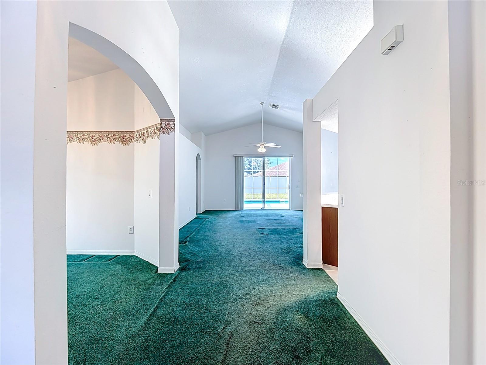 Dining room to left, kitchen to right, living room ahead