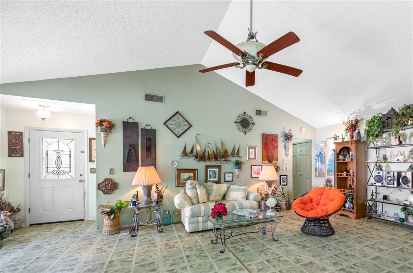The front entry welcomes you into the spacious living room with soaring vaulted ceilings