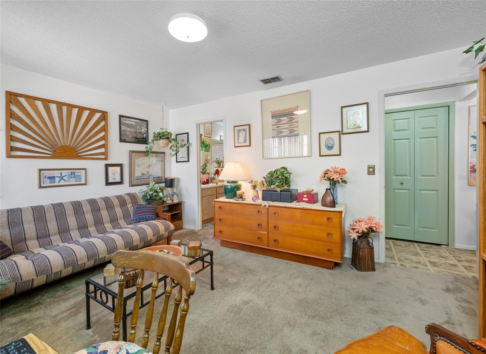 A large second bedroom used as an extra family room/office
