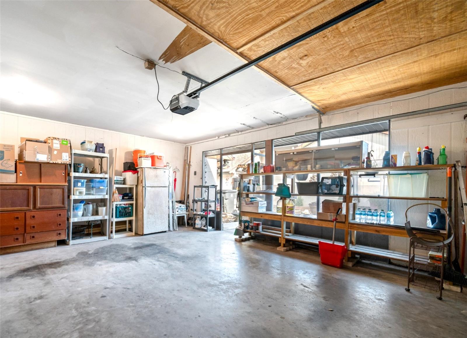 Garage with a wide screened opening provides ample fresh air and light for creative work space