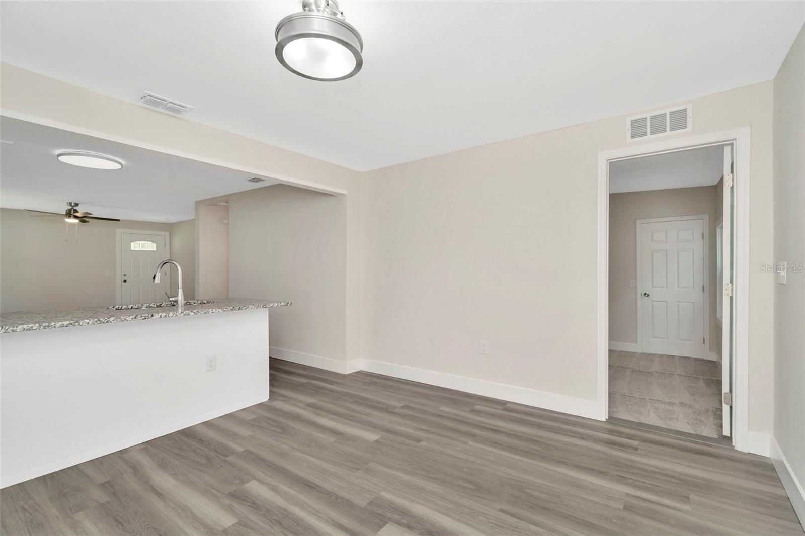 Dining space adjacent to kitchen. Showing doorway to primary bedroom.
