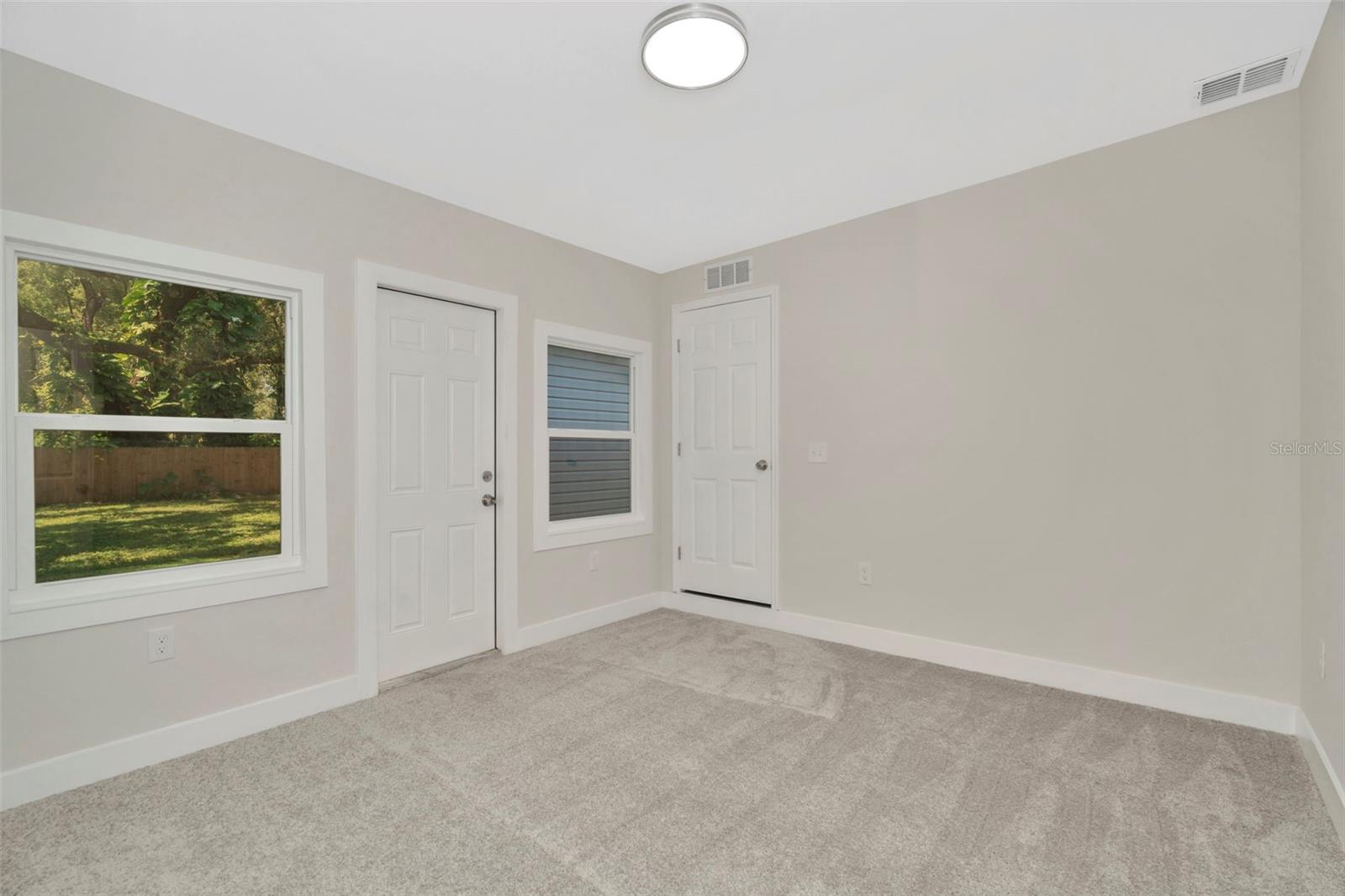 Primary bedroom with private access to back yard and deck.
