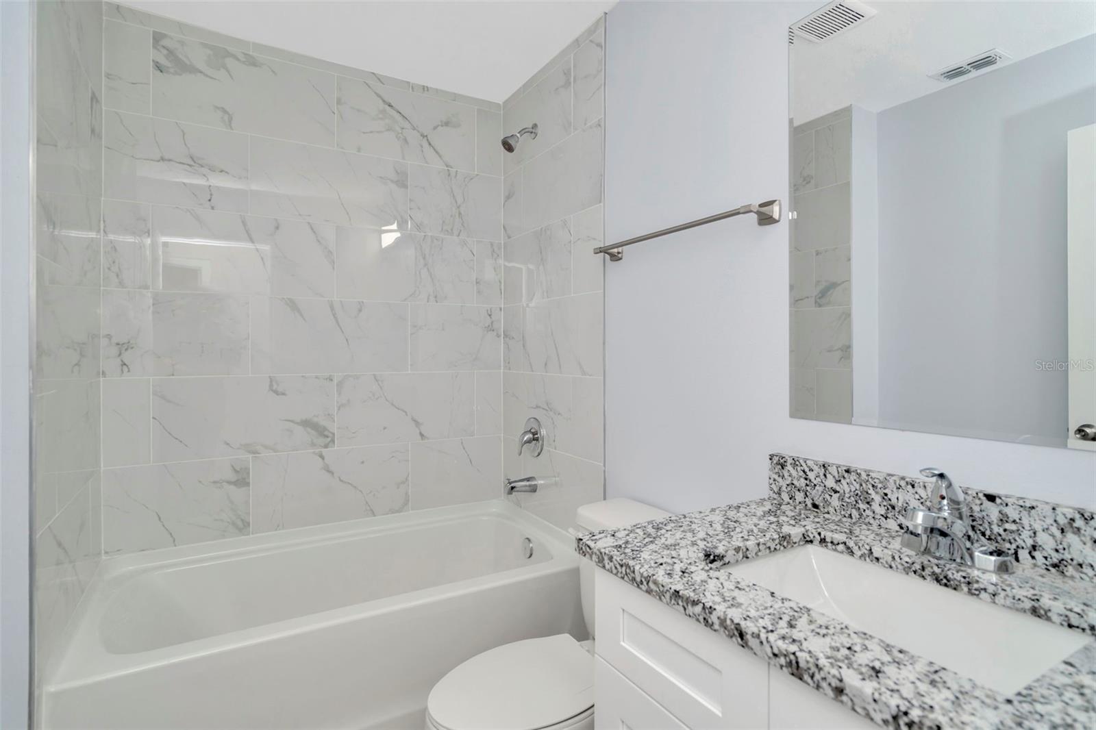 Bathroom two, located in the hallway adjacent to bedroom two and three.