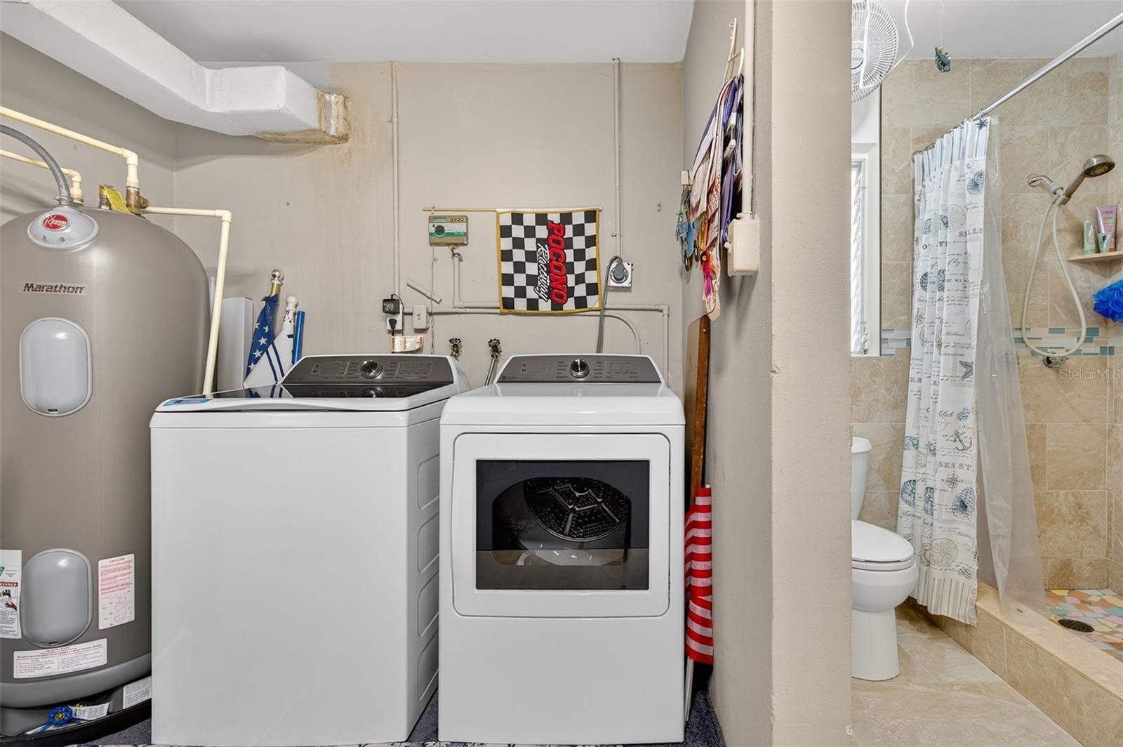 Back of the garage. New GE Profile washer & Dryer, 2nd bath and top of the lone rust-free Rheem Marathon water heater. The back of the garage could be easily enclosed to make it part of the inside. The owner has the original plans as well!
